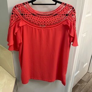 Purchased from boutique. Would call a coral color. In excellent condition